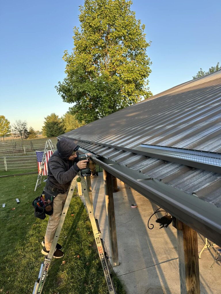 guy in black replacing gutters