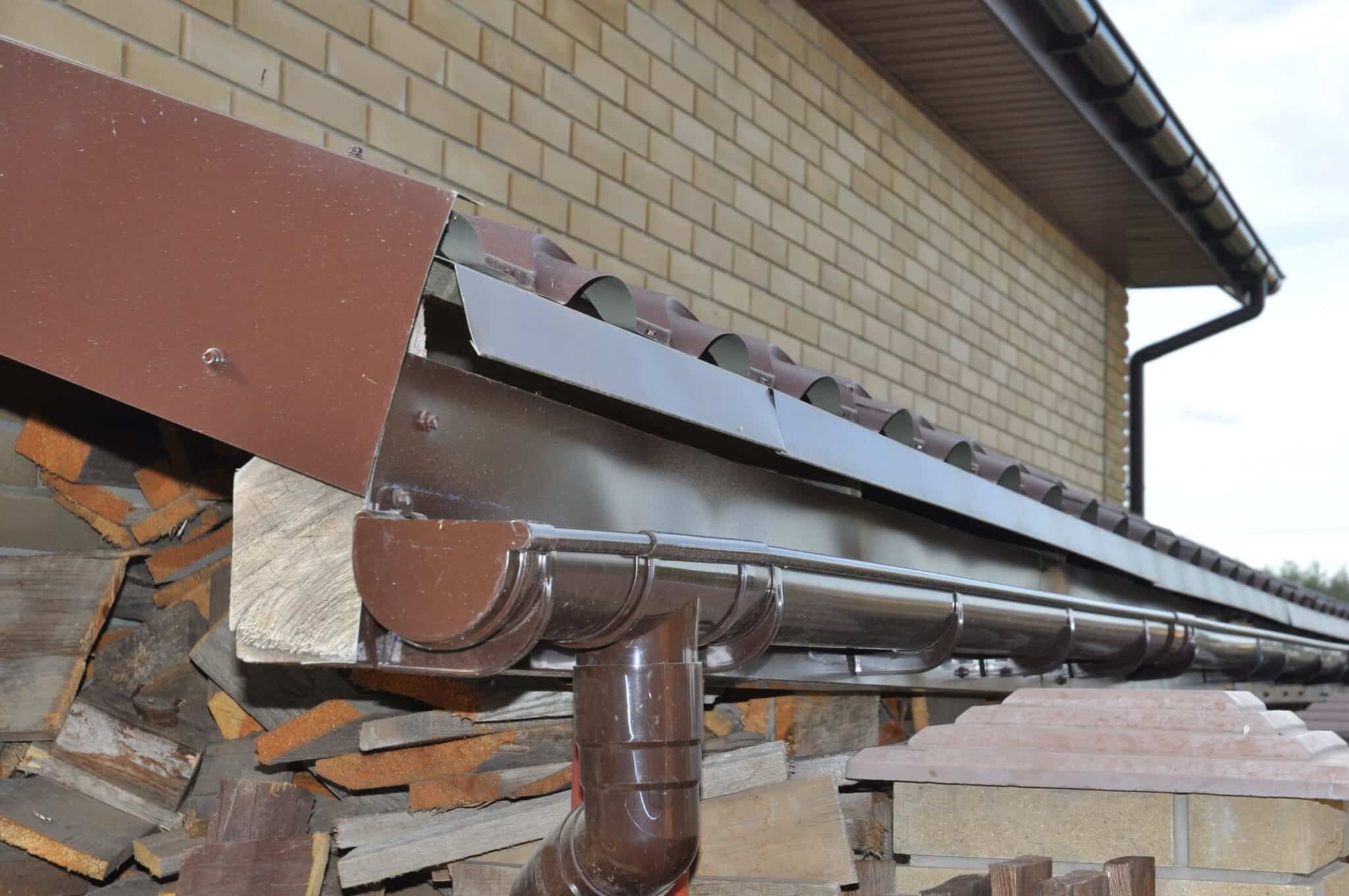 half round gutters installed in a metal roofing